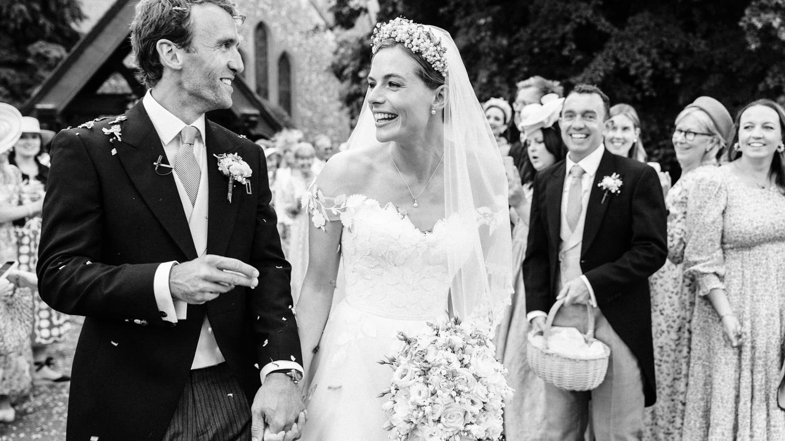 Just married Rosie Tapner & Ross walk through confetti