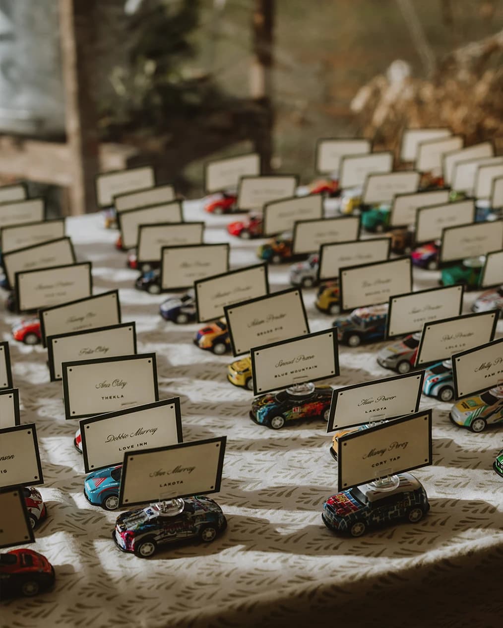 Guest name cards held by toy racing cars