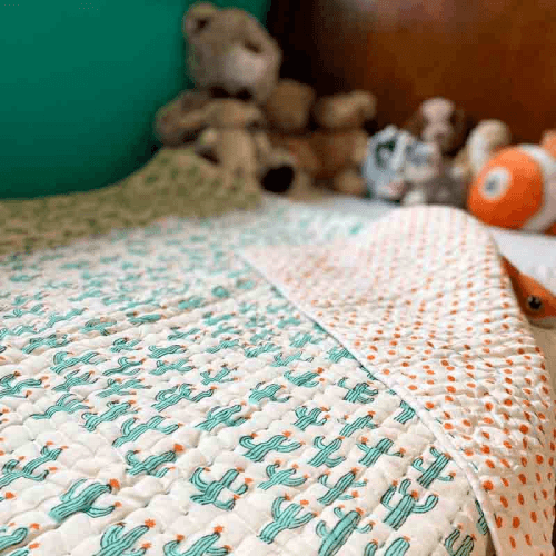 Image showing the Cacti Blockprint Reversible Padded Quilt, 110 x 152cm, White/Jade Green product.